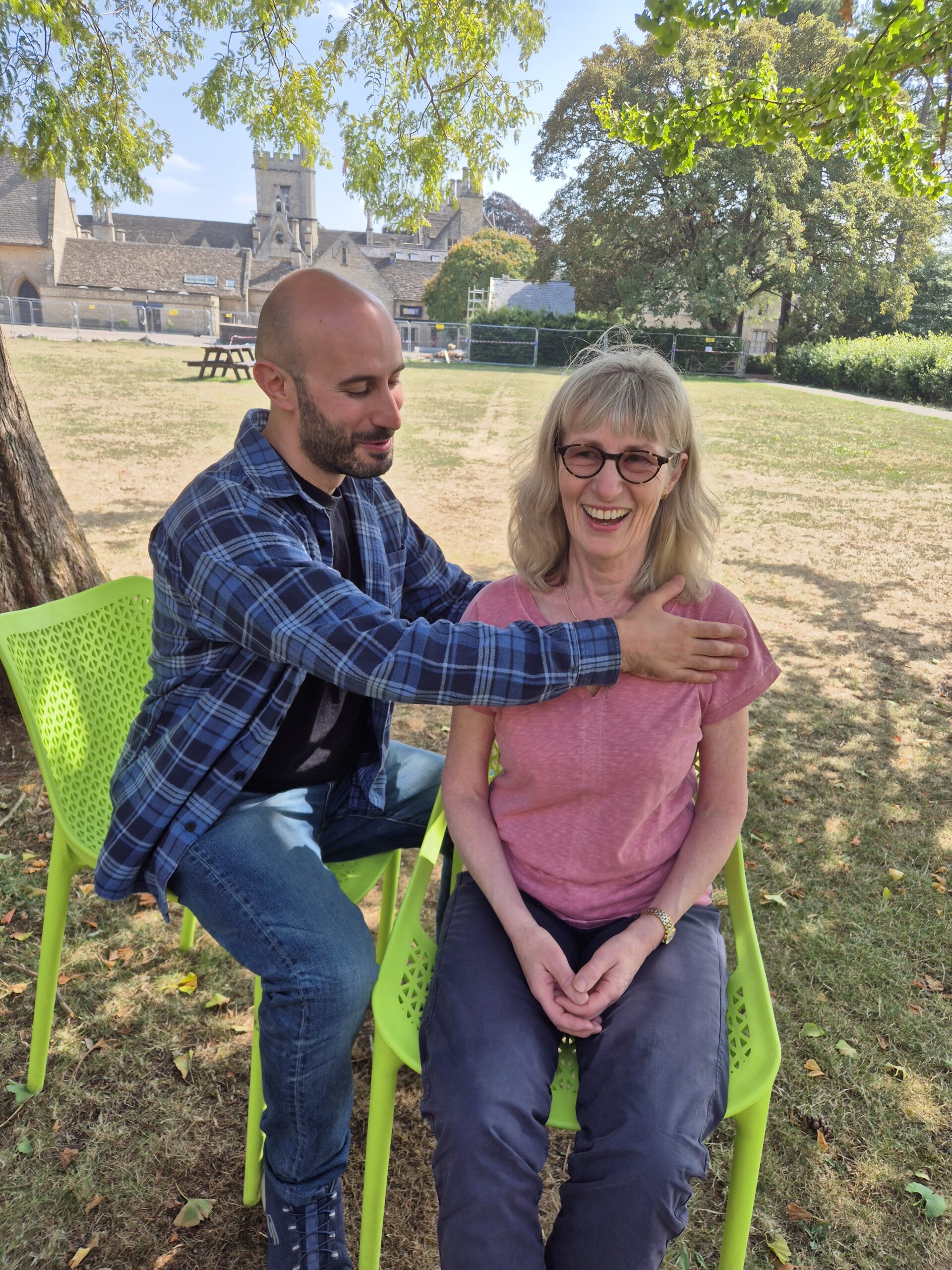 Simon teaching an Alexander Technique lesson, the student seated and smiling